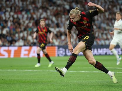 إيرلينغ هالاند يسدد الكرة خلال مباراة بين ريال مدريد ومانشستر سيتي في ذهاب نصف نهائي دوري أبطال أوروبا - 9 مايو 2023 - AFP