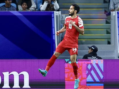 محمود المرضي لاعب الأردن يحتفل بعد تسجيله هدفاً في شباك ماليزيا بكأس آسيا لكرة القدم  - AWB