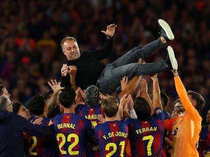 لاعبو برشلونة يحملون المدرب هانزي فليك احتفالاً بالفوز بلقب الدوري الإسباني - 10 مايو 2026 - Reuters