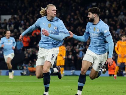 هالاند يحتفل مع غفارديول بعد أن سجل هدفه الأول في مسيرته الكروية أمام ريال مدريد بدوري أبطال أوروبا 11-2-2025 - Reuters