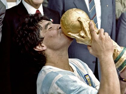 مارادونا يقبل كأس العالم بعد التتويج بمونديال 1986 - AFP