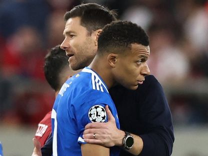 عناق بين مدرب ريال مدريد تشابي ألونسو ومهاجمه كيليان مبابي بعد نهاية مباراة أولمبياكوس في دوري أبطال أوروبا - 26 نوفمبر 2025 - REUTERS