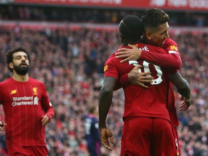 لاعبو ليفربول يحتلفون بعد تسجيل هدف في الدوري الإنجليزي الممتاز - AFP