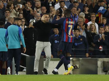 لاعب برشلونة عثمان ديمبلي يحتفل مع مدربه تشافي هرنانديز بعد تسجيله هدفاً في شباك إنتر ميلان - 12 أكتوبر 2022  - REUTERS