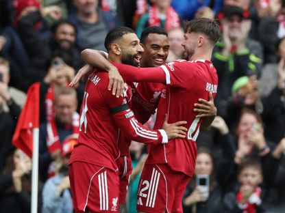 محمد صلاح (يسار) يحتفل مع ريان غرافينبيرخ (وسط) وكونور برادلي بعد هدف ليفربول ضد إيفرتون - 20 سبتمبر 2025 - Reuters