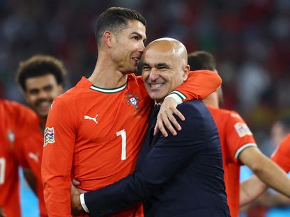 مدرب البرتغال روبرتو مارتينيز يحتفل مع كريستيانو رونالدو بعد الفوز على إسبانيا في نهائي دوري الأمم الأوروبية - 8 يونيو 2025 - Reuters
