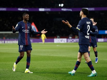 عثمان ديمبيلي يحتفل مع أشرف حكيمي بهدفه في مباراة باريس سان جيرمان وتولوز بالدوري الفرنسي - 3 أبريل 2026 - Reuters