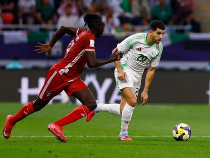 يوسف عطال لاعب الجزائر في صراع على الكرة مع مازن فضول لاعب السودان في مواجهة الفريقين بكأس العرب - 3 ديسمبر 2025 - Reuters