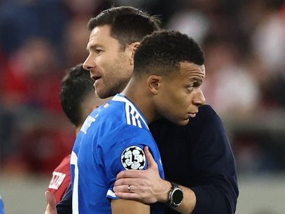 عناق بين مدرب ريال مدريد تشابي ألونسو ومهاجمه كيليان مبابي بعد نهاية مباراة أولمبياكوس في دوري أبطال أوروبا - 26 نوفمبر 2025 - REUTERS